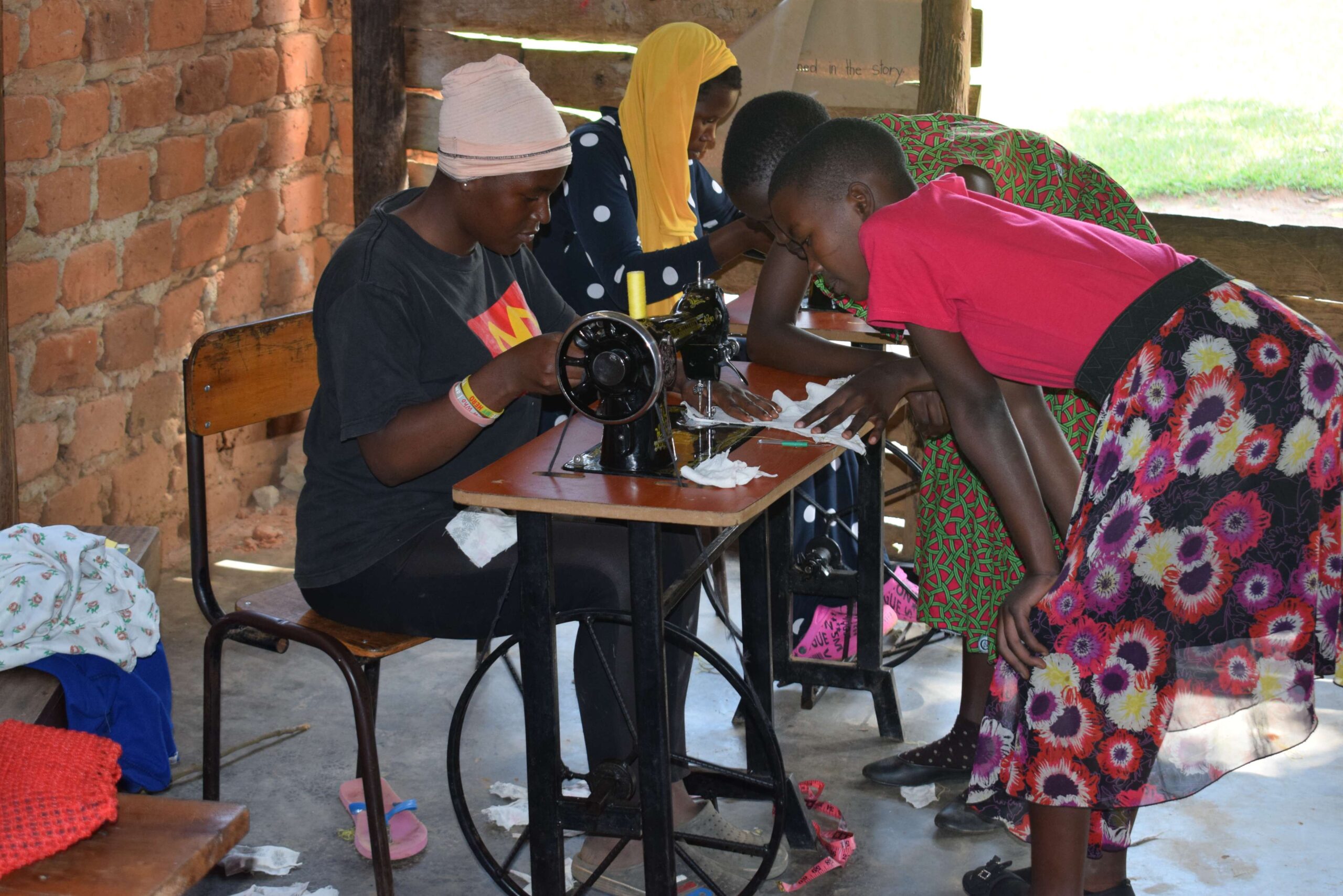 Children learning to tailor their uniforms